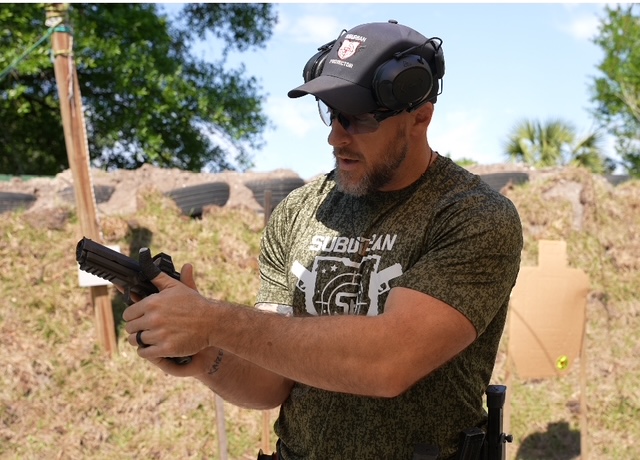 Mike showing students how to grip a gun